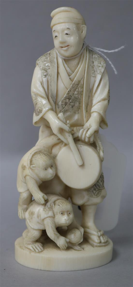 A Japanese carved figure with monkeys